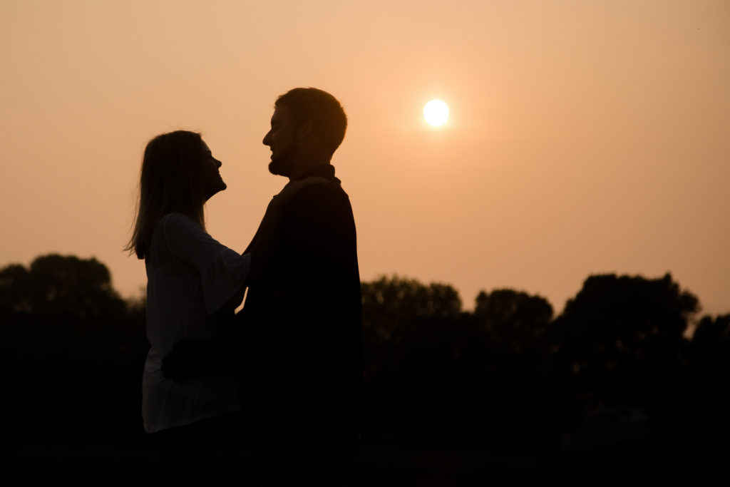 silhoette of hazy sunset port burwell engagement photography by london ontario photographer Woodgate Photography