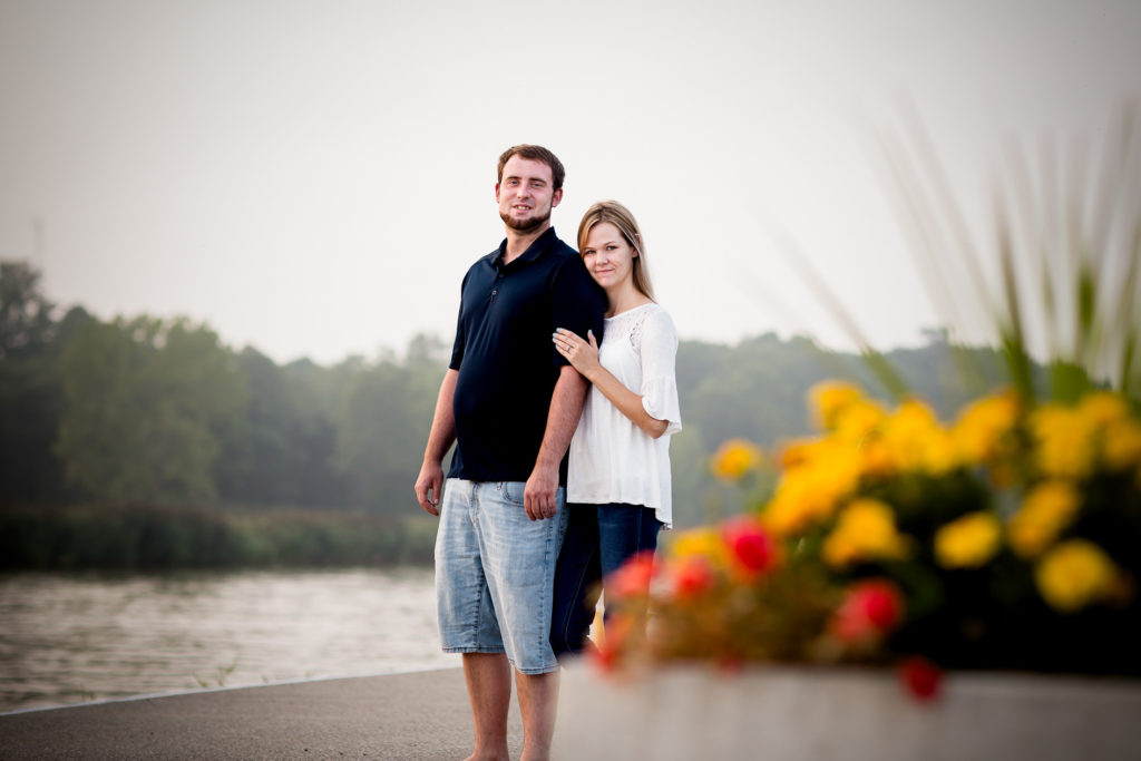 couple hug looking at the camera port burwell engagement photography by london ontario photographer Woodgate Photography