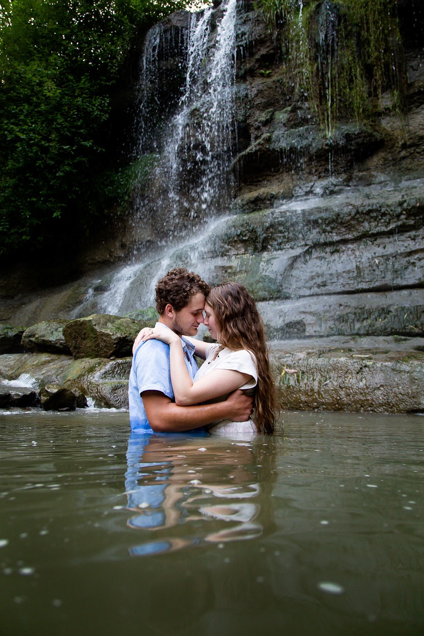 couple in water at rock glen waterfall in arkona ontario engagement photography