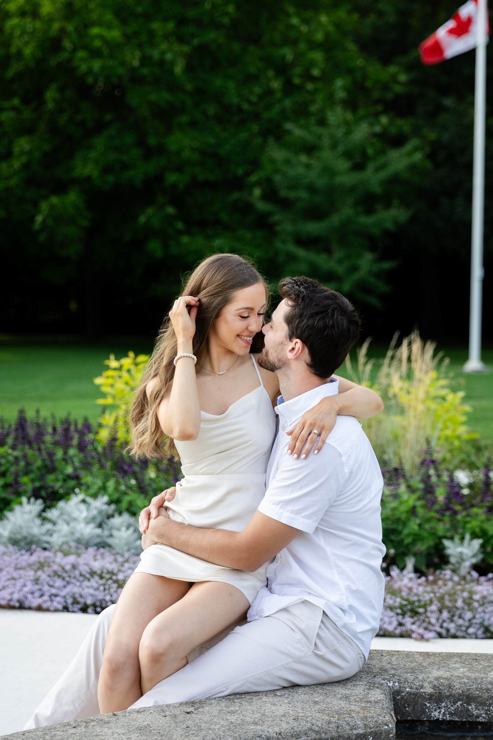 summer Engagement Photography London Ontario at civic gardens sitting on lap