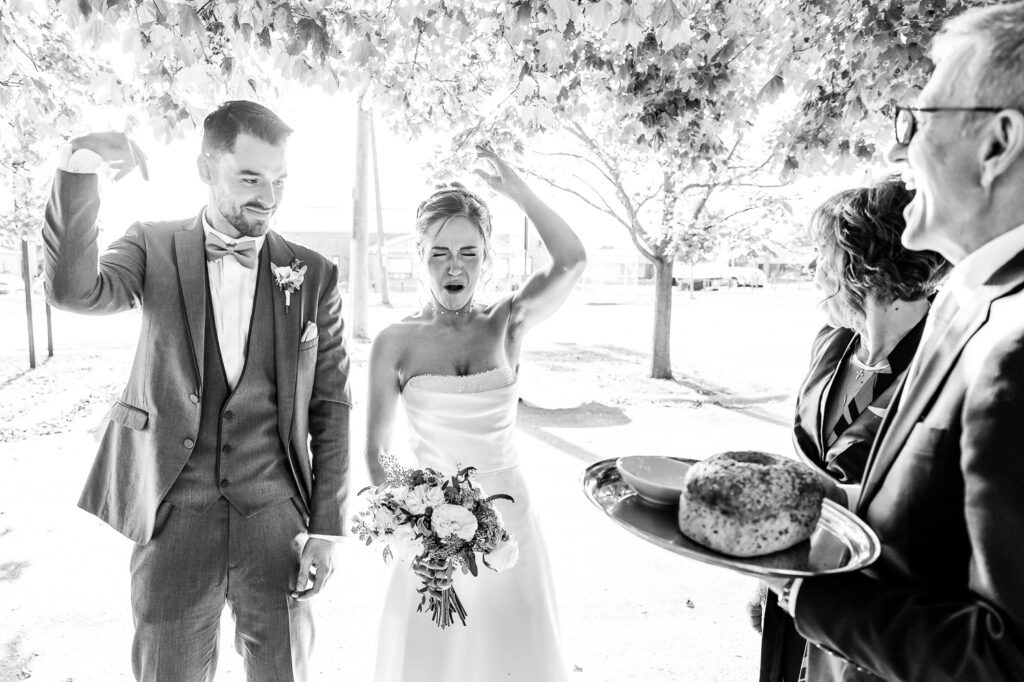 Candid Wedding Photographs London Ontario couple taking a traditional shot of vodka or water