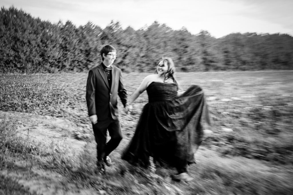couple hold hands walking black and white wedding photography london ontario