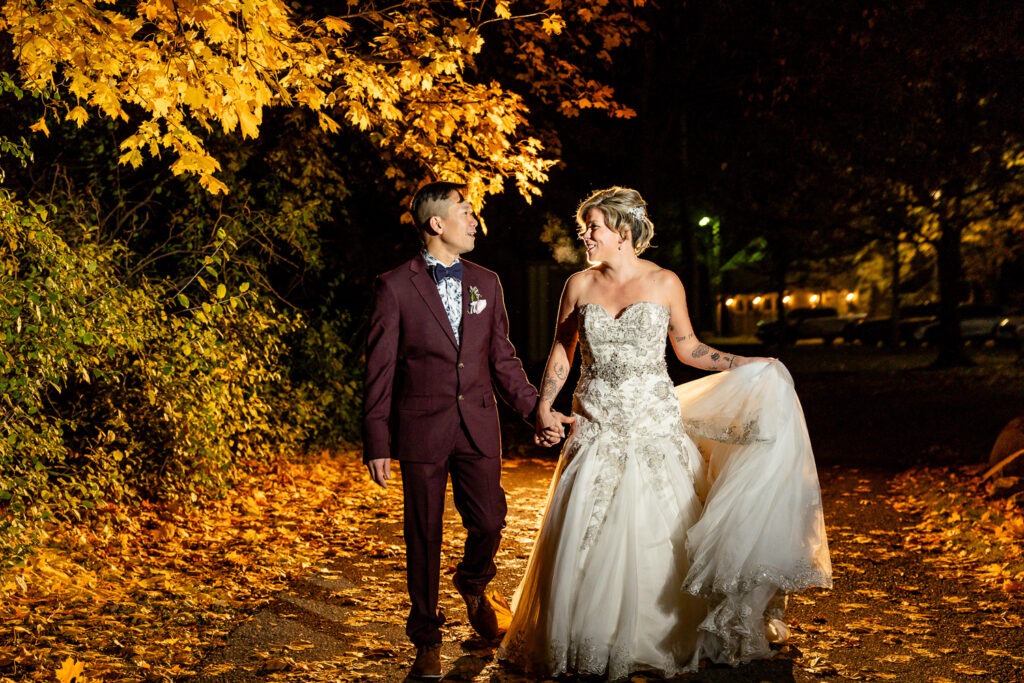 couple walk holding hands dramatically lit walking towards camera wedding photography london ontario